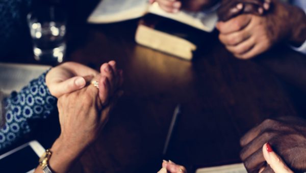 Group of people praying worship believe hope