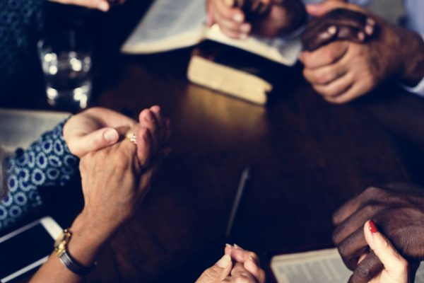 Group of people praying worship believe hope